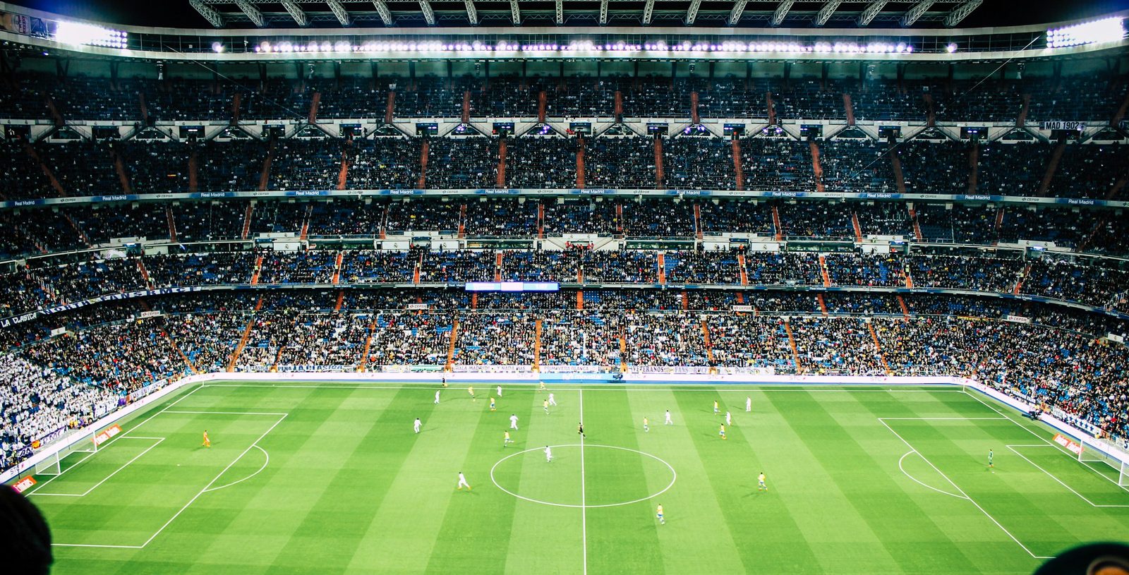 A packed football stadium under floodlights, streamed live on Zentrix TV